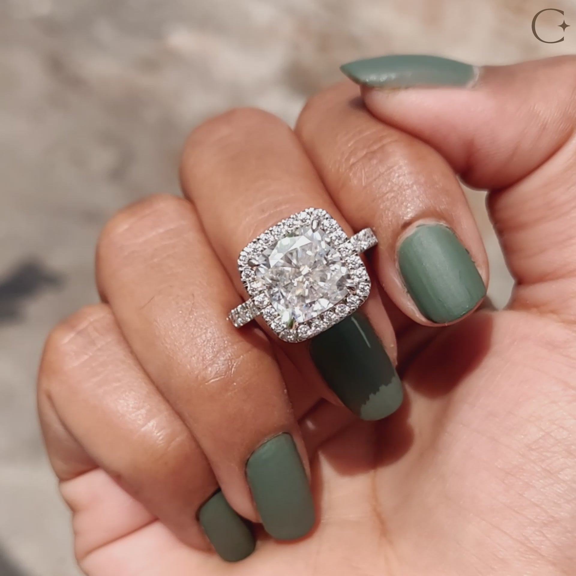 A cushion engagement ring halo frames the center stone beautifully.