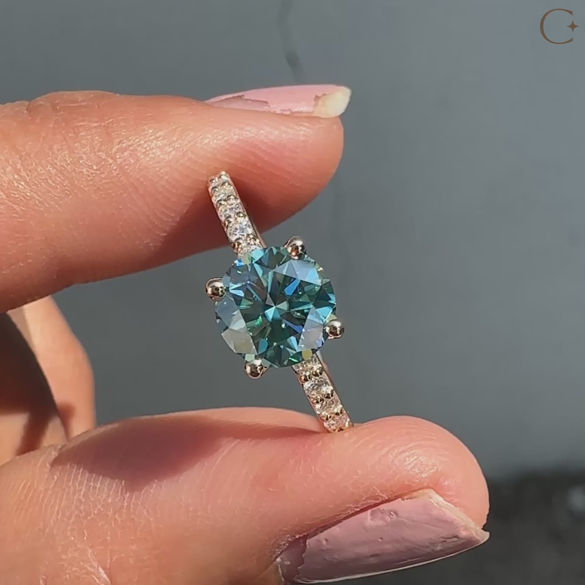 This cyan blue round cut ring pairs beautifully with a pave setting for a clean and stylish design.