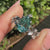 Cyan blue moissanite pear ring with round side stones
