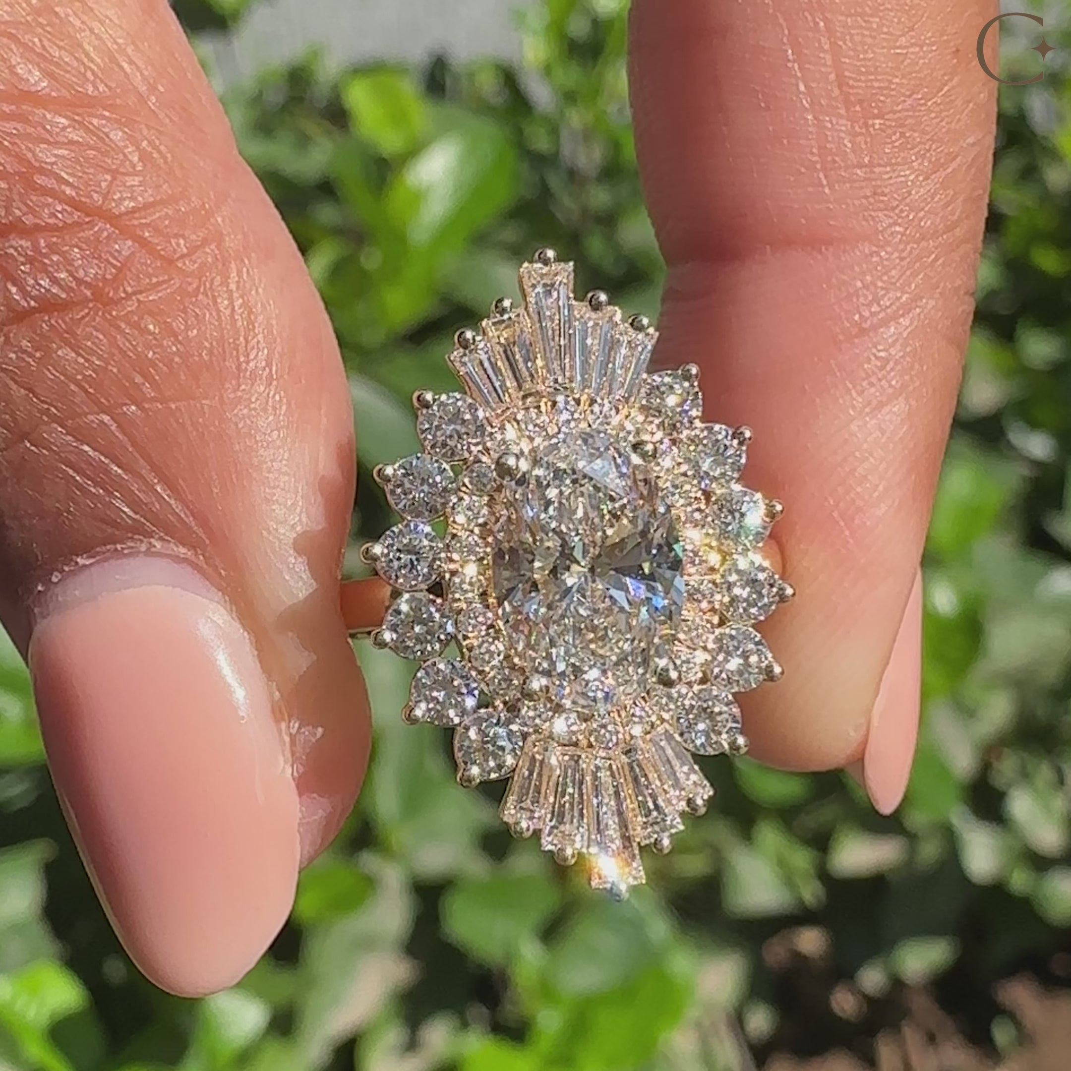 Oval engagement ring with tapered baguettes and four prongs
