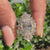 Oval engagement ring with tapered baguettes and four prongs
