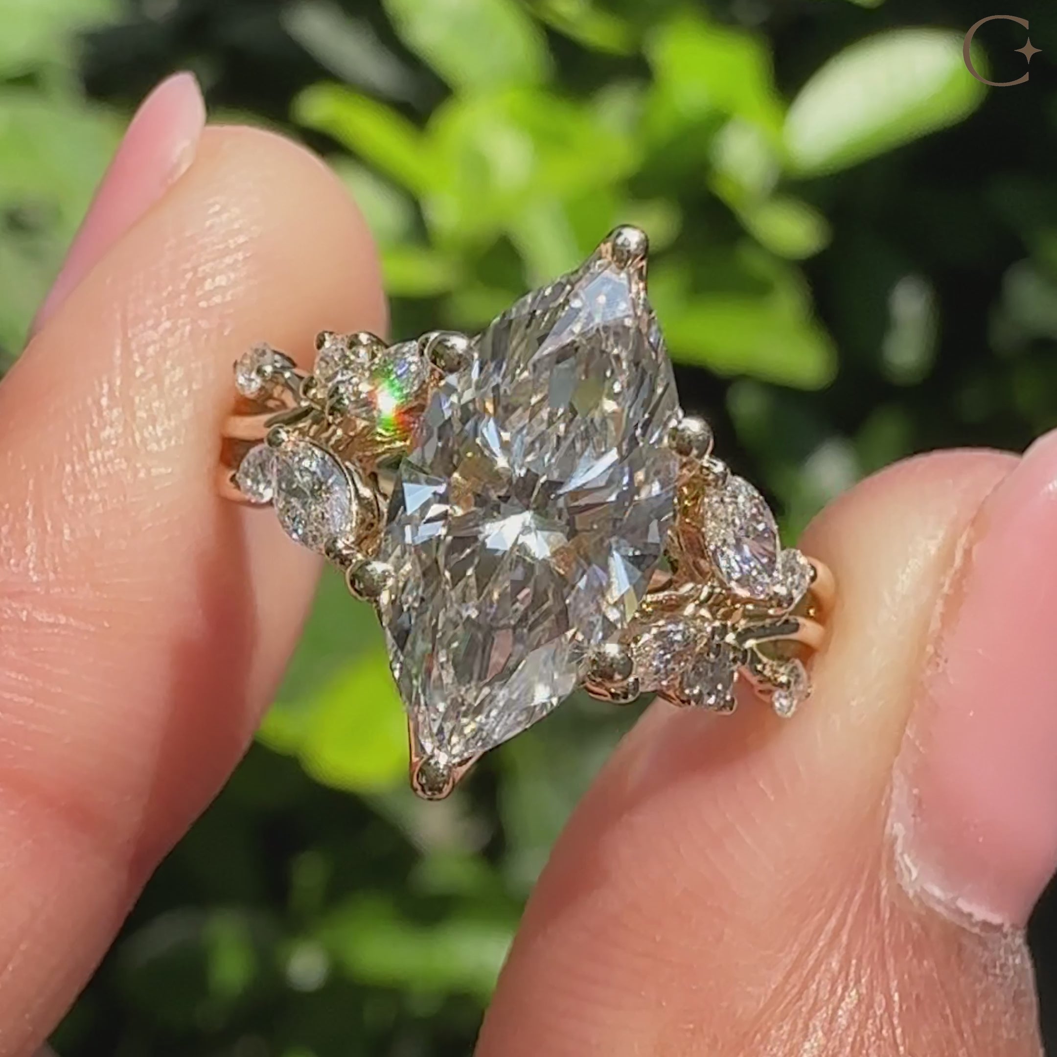 Marquise diamond ring with twisted shank and side stones.
