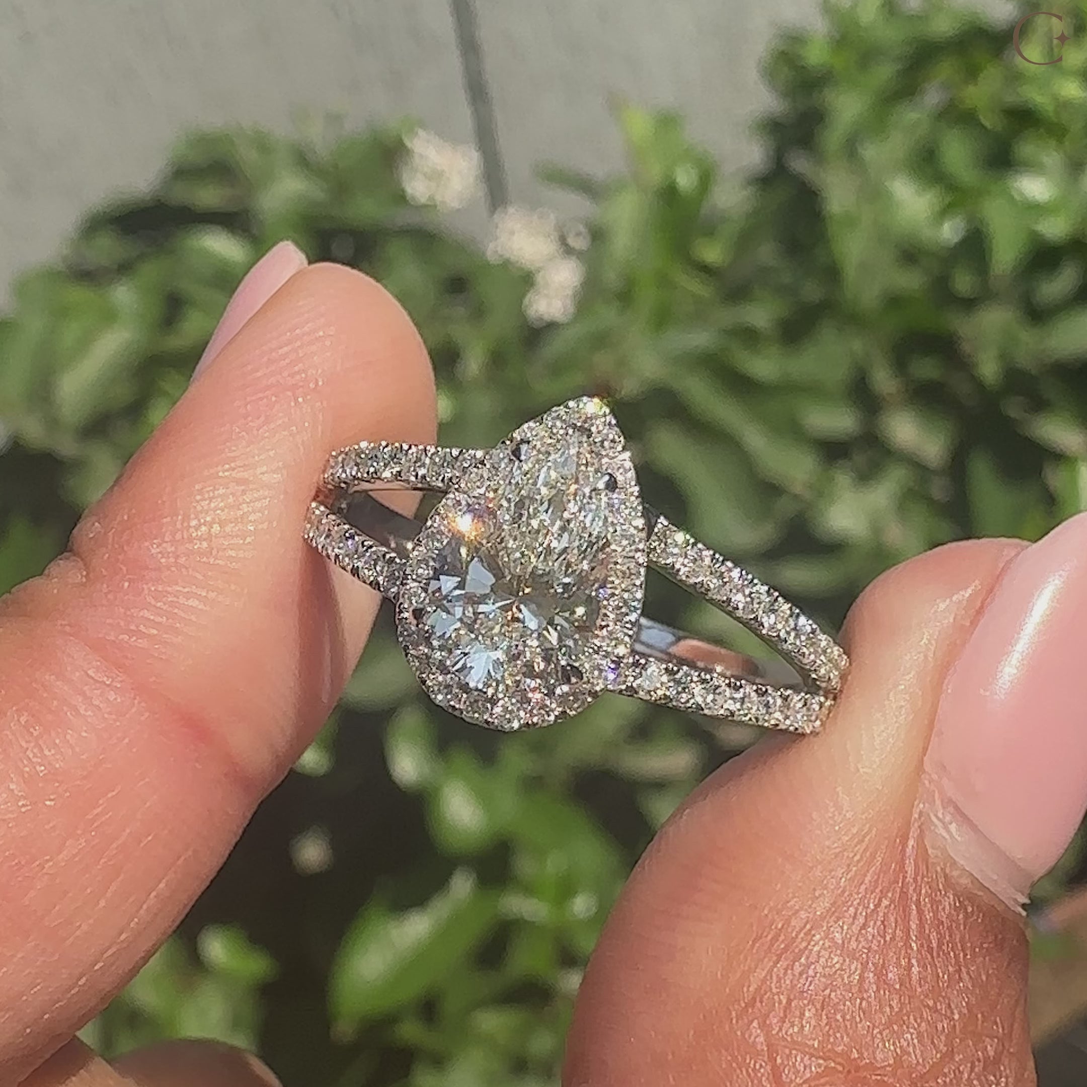 Carat diamonds ring with split shank band, pear cut center, and handmade craftsmanship.