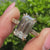 3.00 carat emerald cut diamond ring with round pave.
