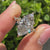 Marquise cut engagement ring designed with cluster and round accents.
