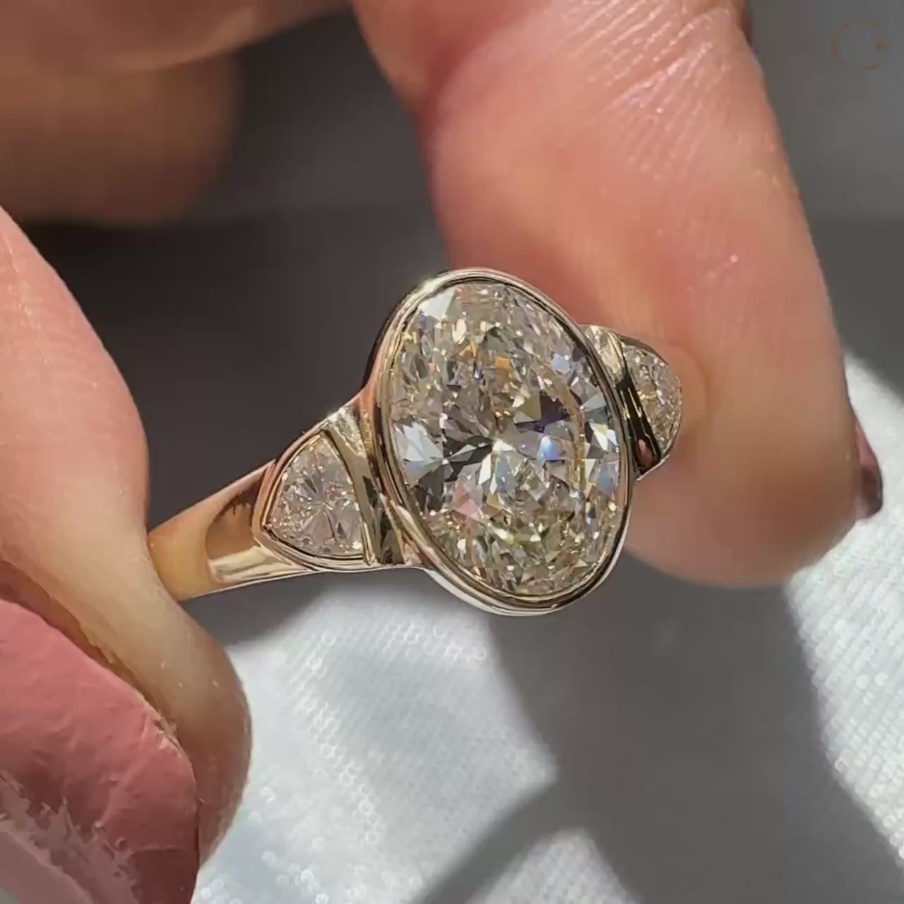 Bezel setting ring with 3 stone engagement ring.
