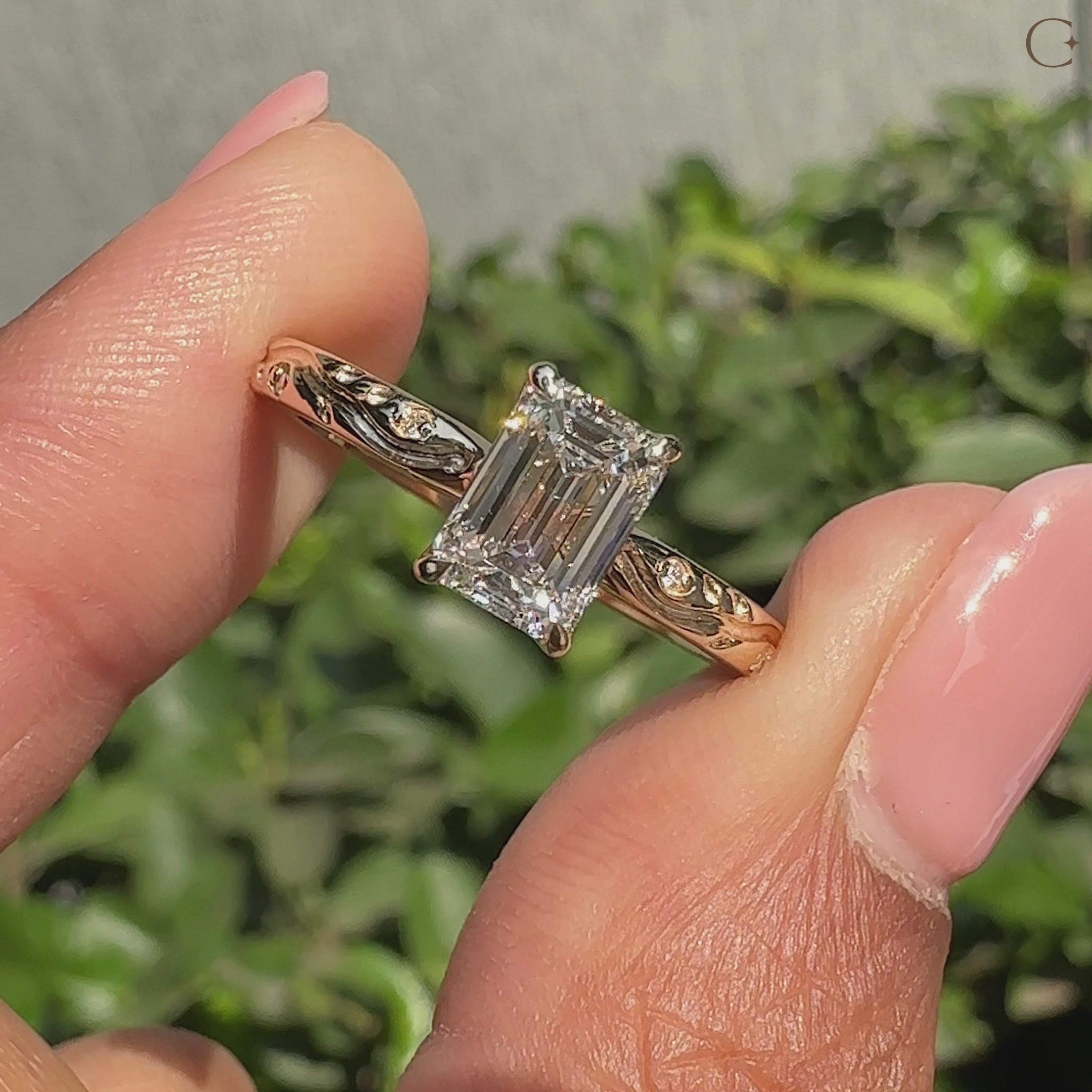 Emerald cut diamond ring with round side stones.
