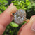 Sparkling round cut halo design enhances oval cut diamond ring.

