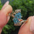 Nature inspired blue Dutch marquise ring with round diamond leaf accents.
