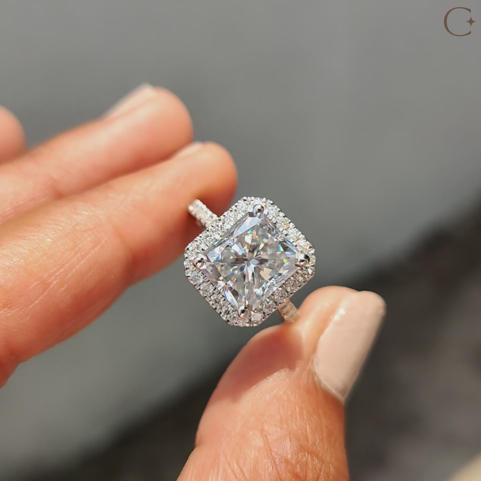 Round cut halo setting wraps soft shine around gems.