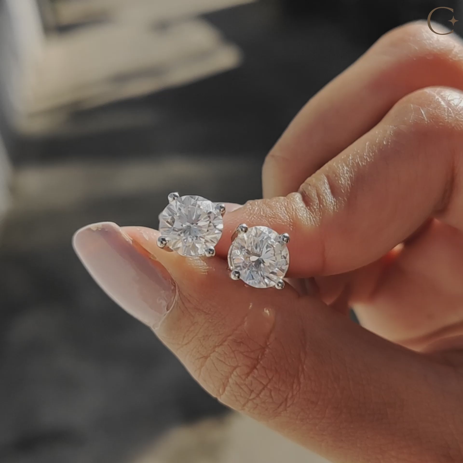 Carat Diamonds earrings collection offering handmade earrings with round cut stud earrings in white gold.