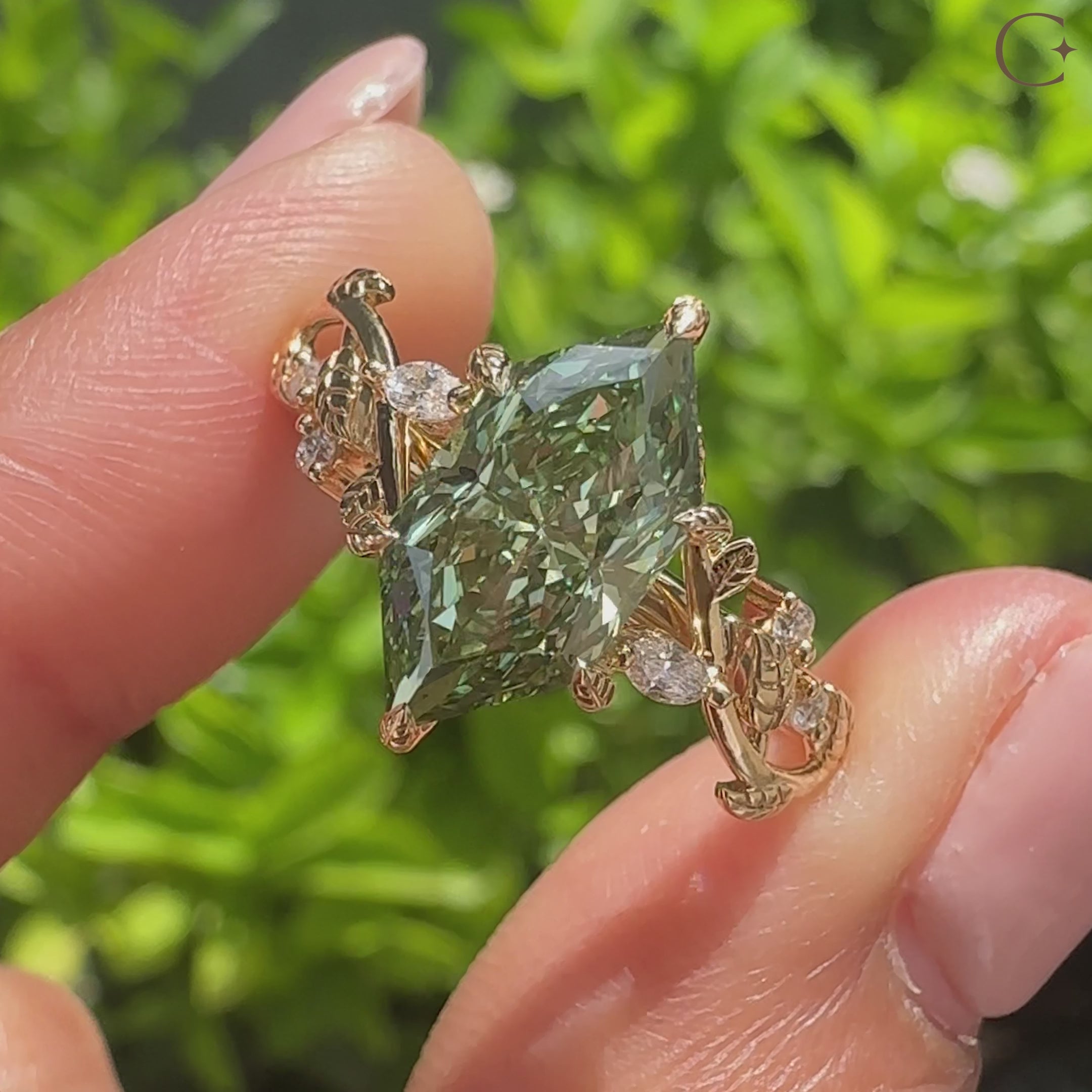 Green diamond ring with marquise and round side stones

