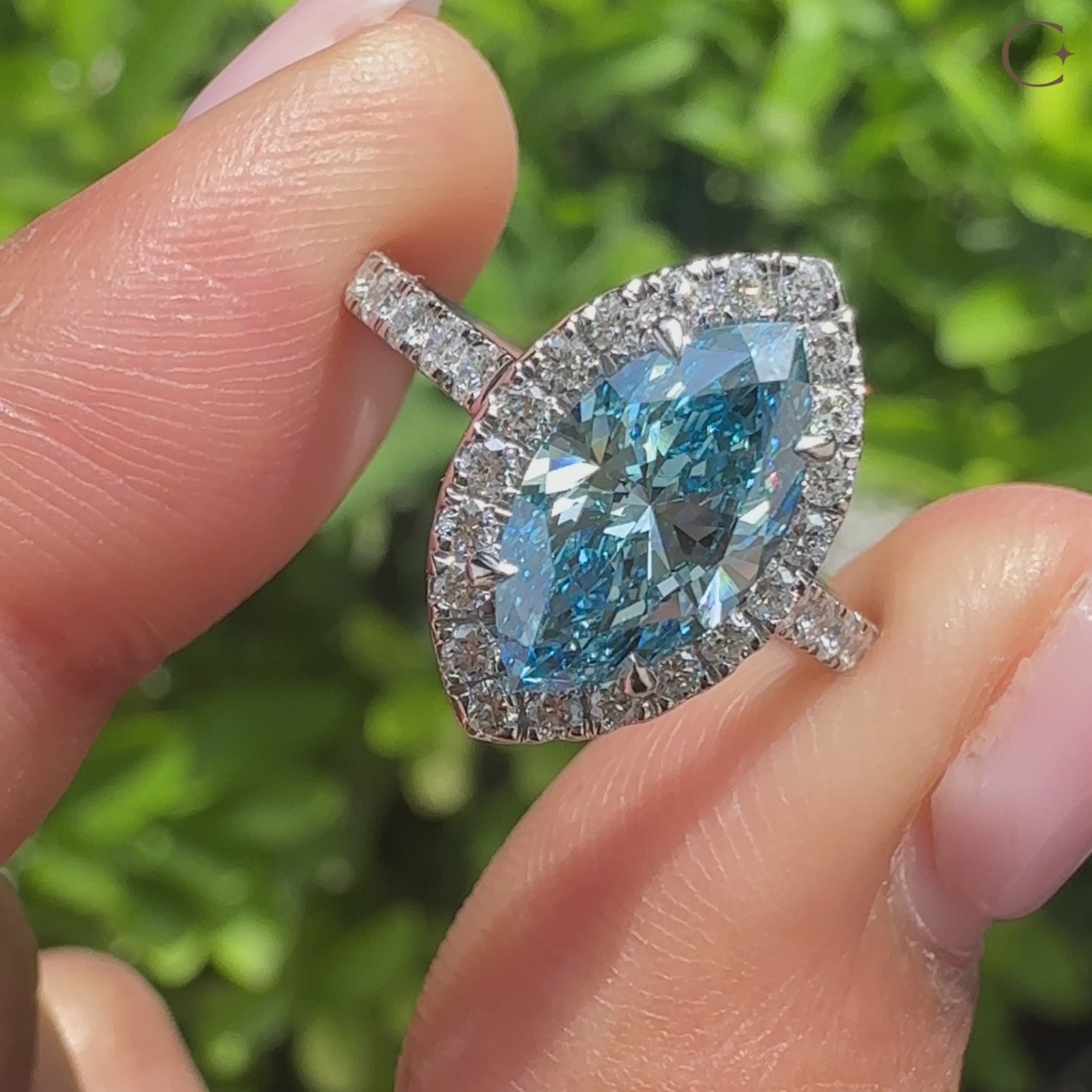 Marquise lab diamond ring with blue center and halo