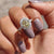 Engagement ring micro pave setting with a round cut moissanite stone.