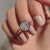 A bezel set solitaire ring offers a modern and secure setting.
