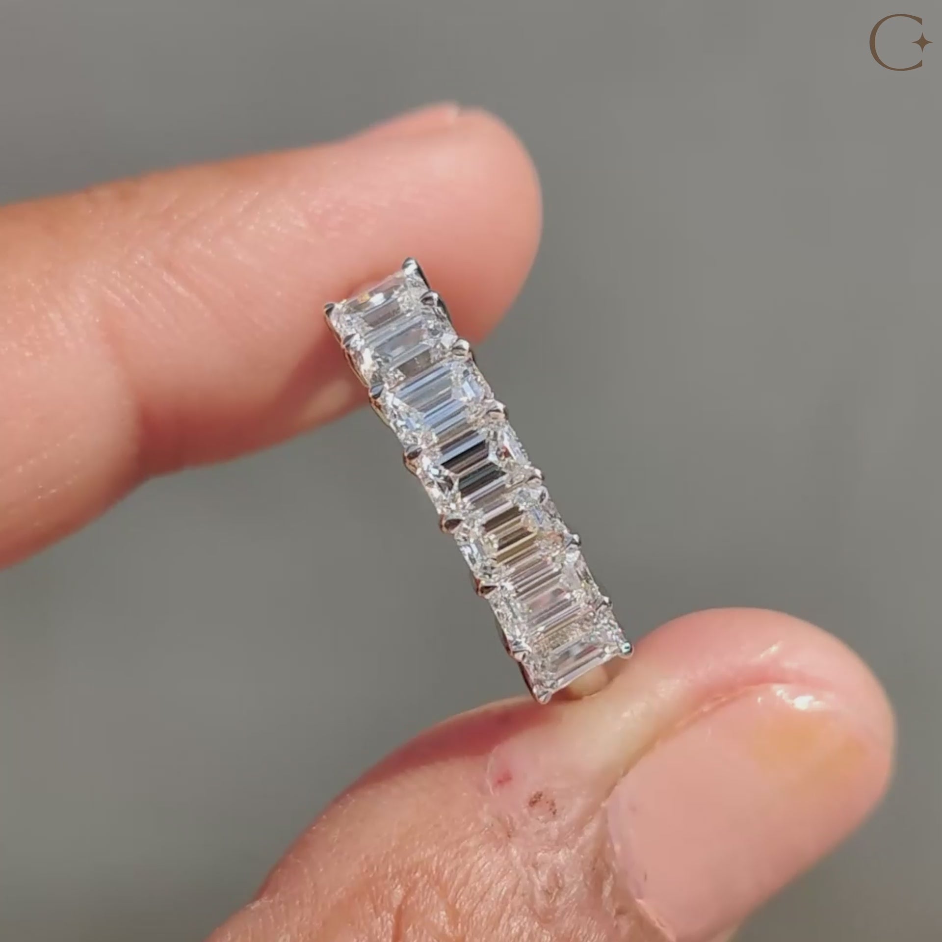 Emerald cut diamond wedding band with seven stunning stones.
