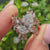 Pear diamond ring with marquise and round side stones
