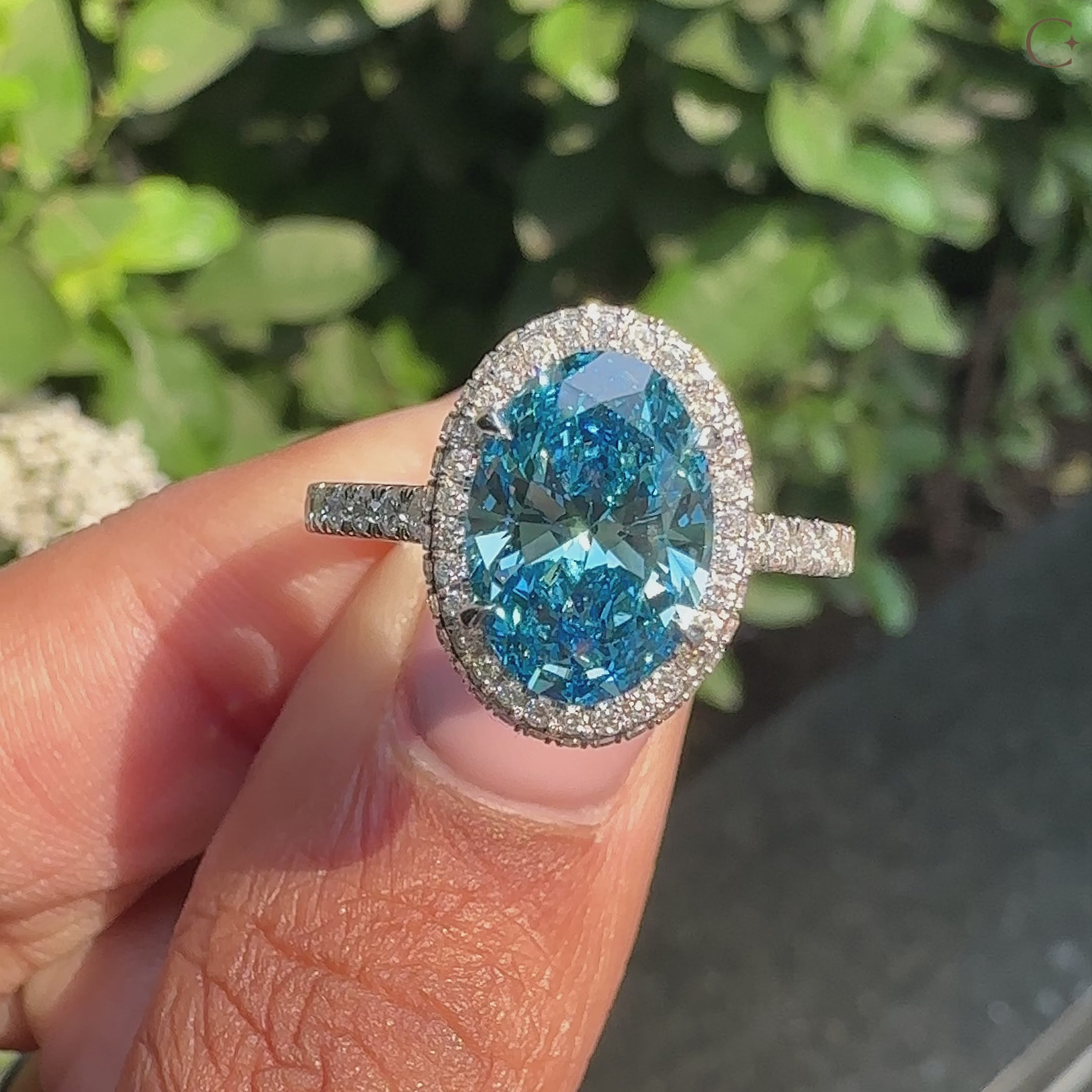 Oval halo blue diamond ring with pave band
