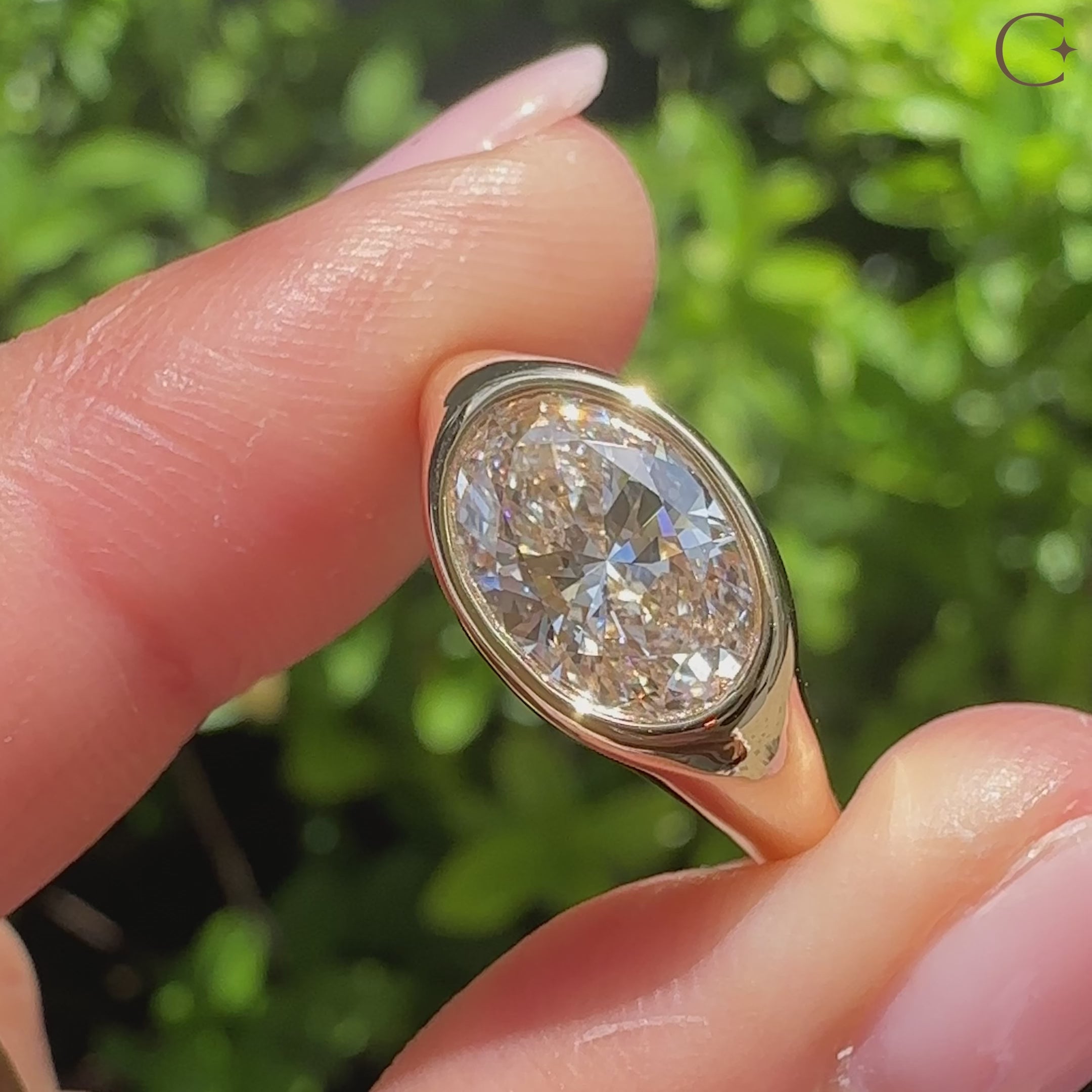 Oval diamond ring with bezel setting and chunky shape
