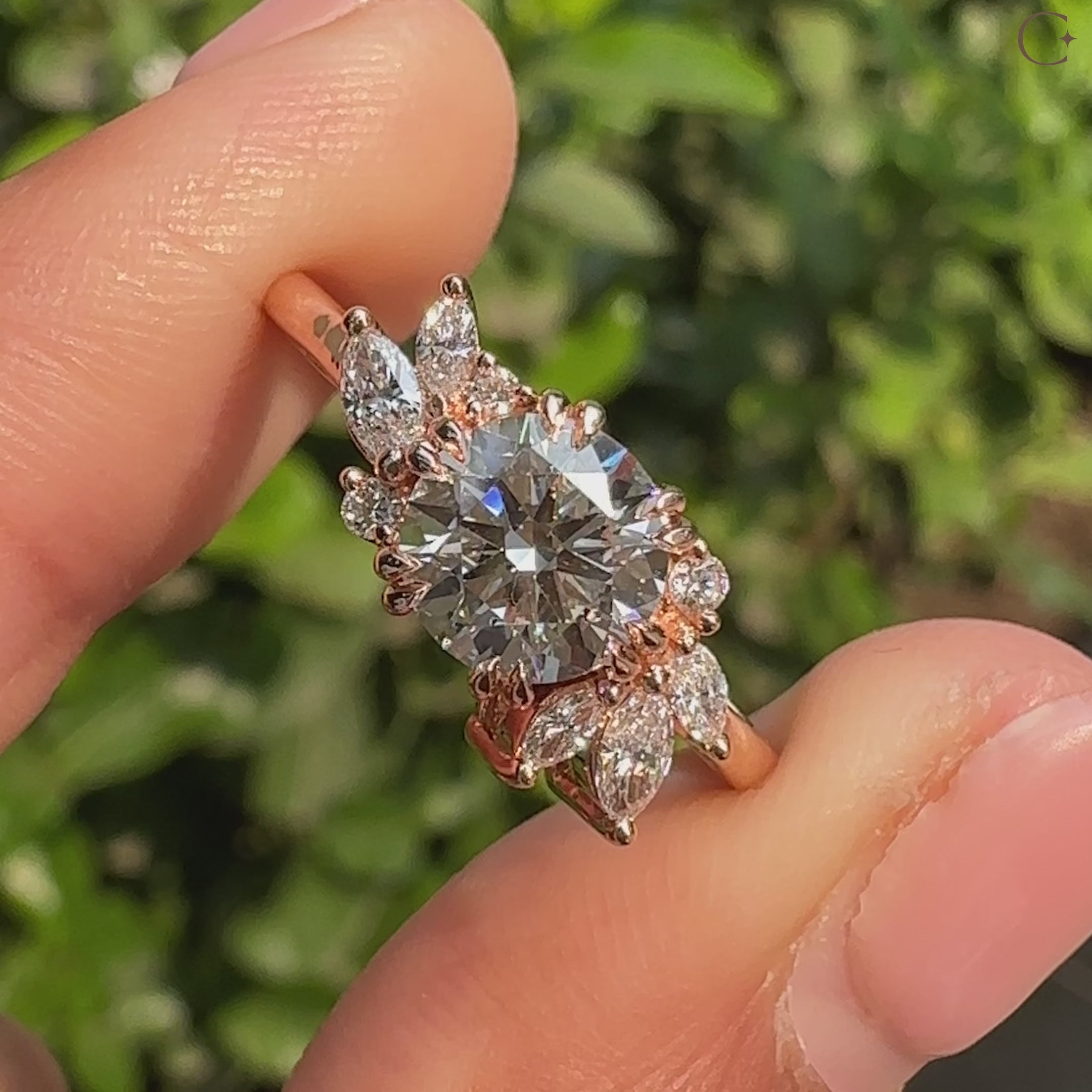 Round diamond ring with marquise and round side stones.