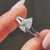 Hidden halo pear engagement ring with a stunning design that highlights the diamond's brilliance.
