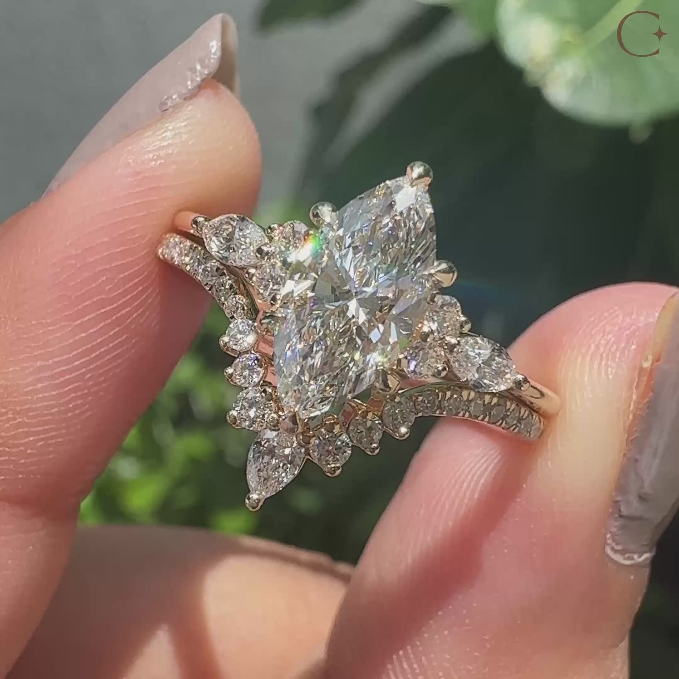 Muse setting marquise and round side stone bridal ring design.