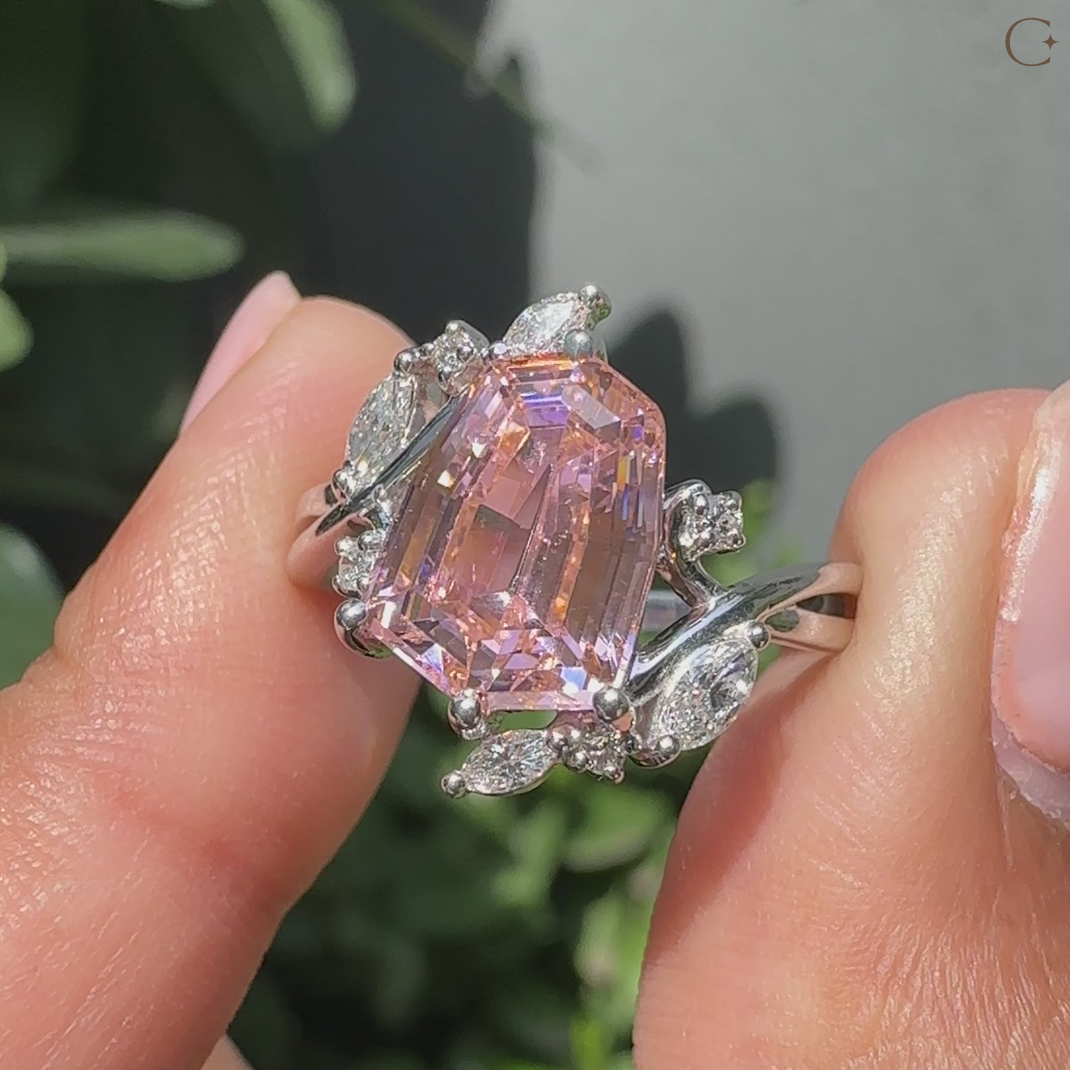 Pink gemstone engagement ring in white gold setting.