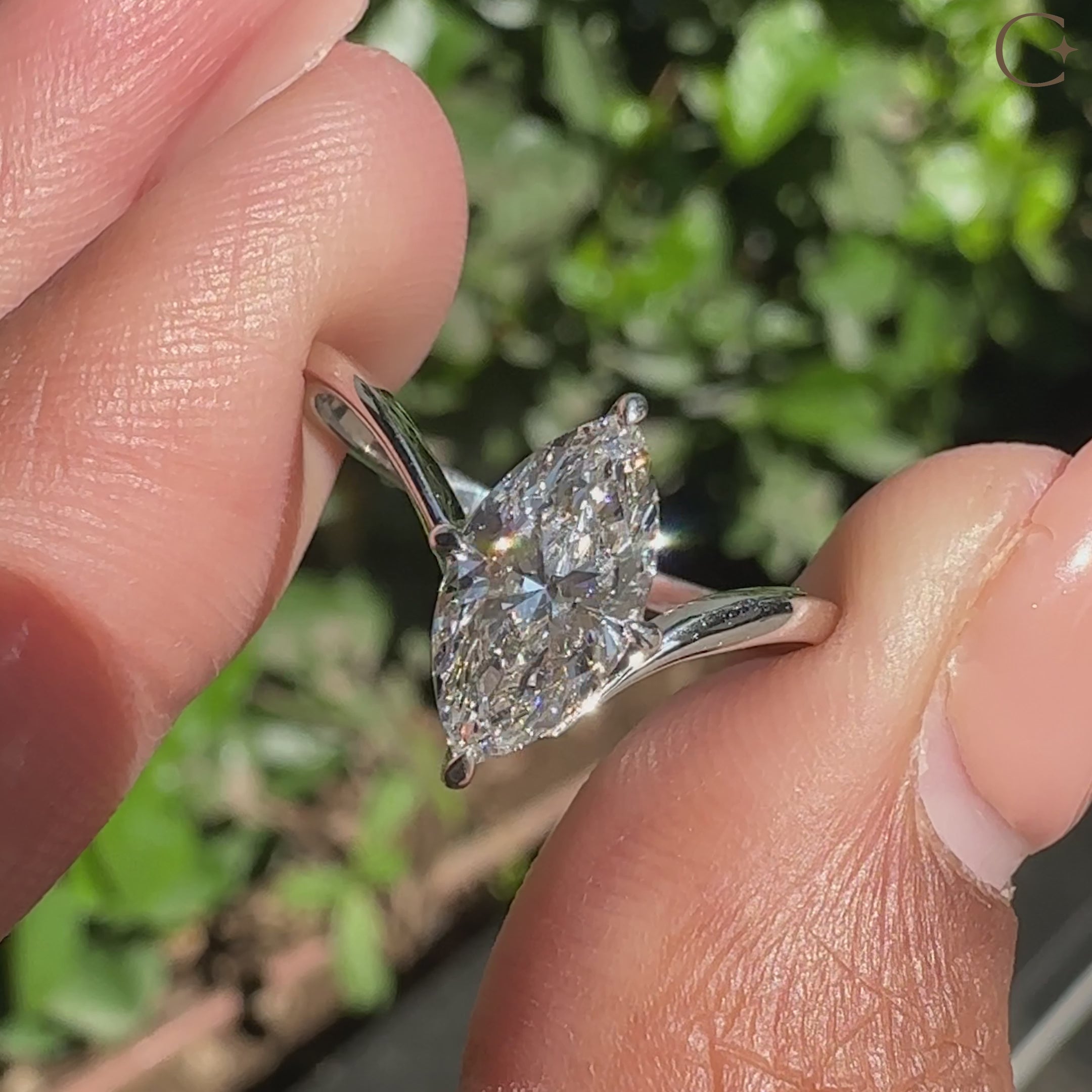 Marquise diamond engagement ring with compass claw prong setting.