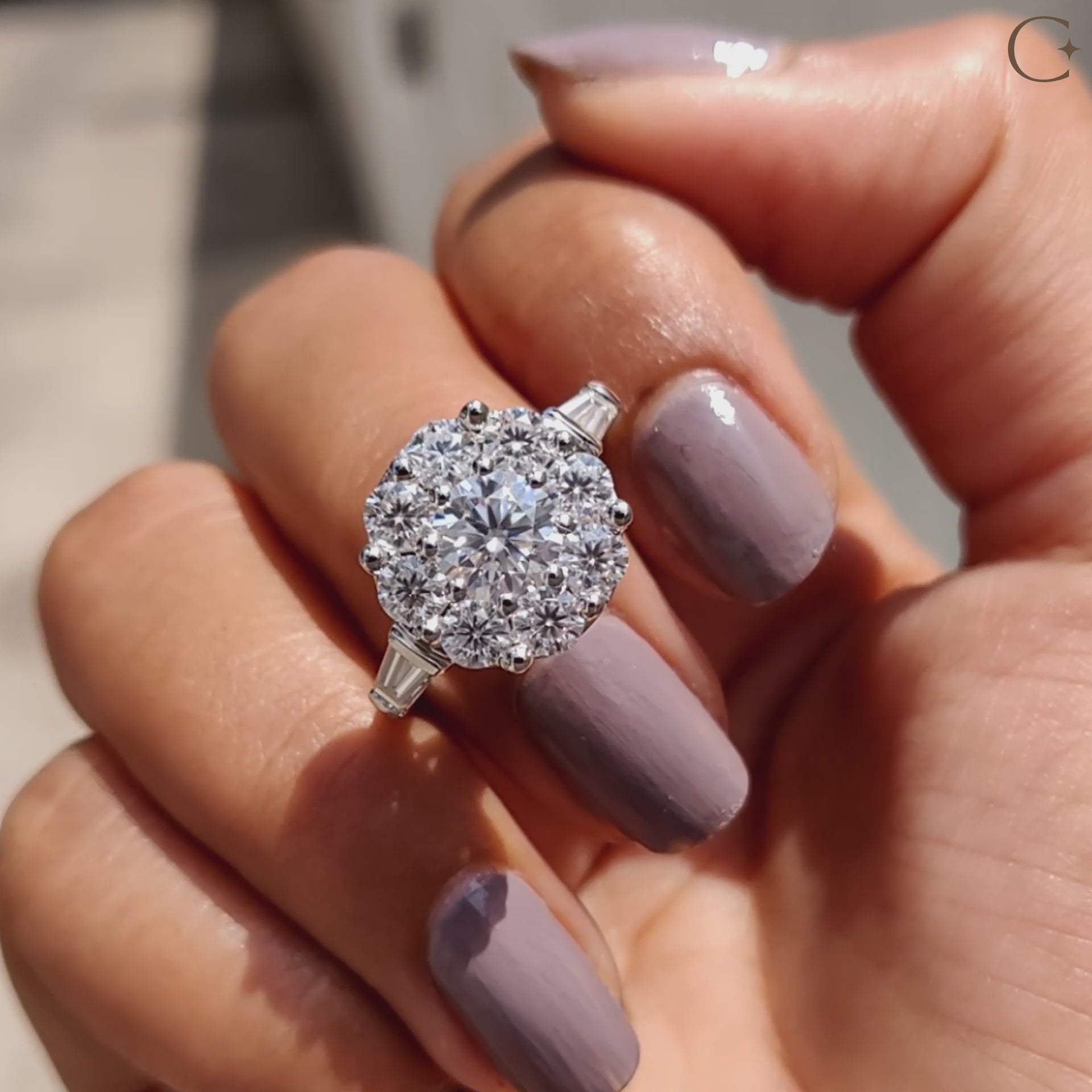 A round halo engagement ring features a sparkling stone frame.