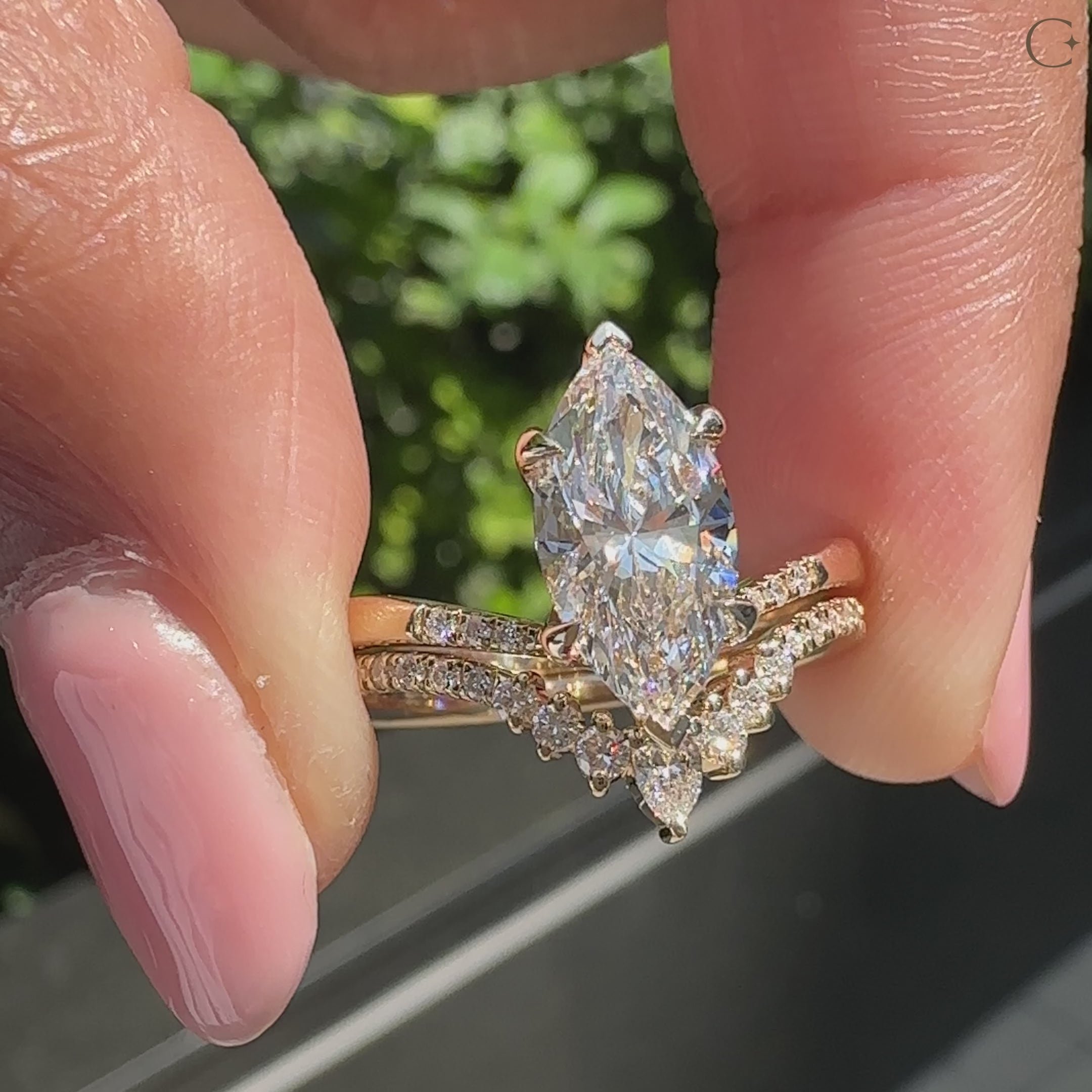 Engagement ring with curved diamond band set.
