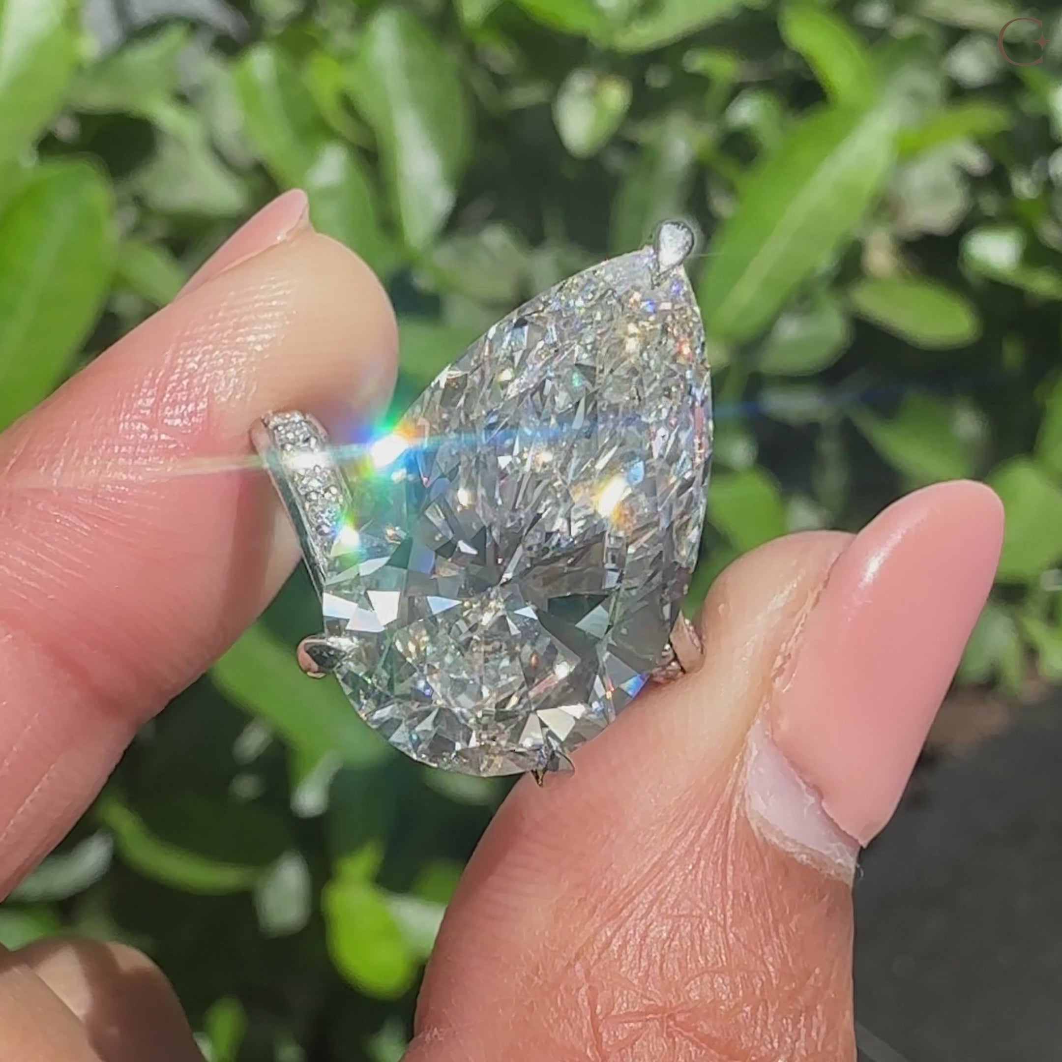 Lab grown pear diamond ring featuring round diamond double row pave and a bypass design.
