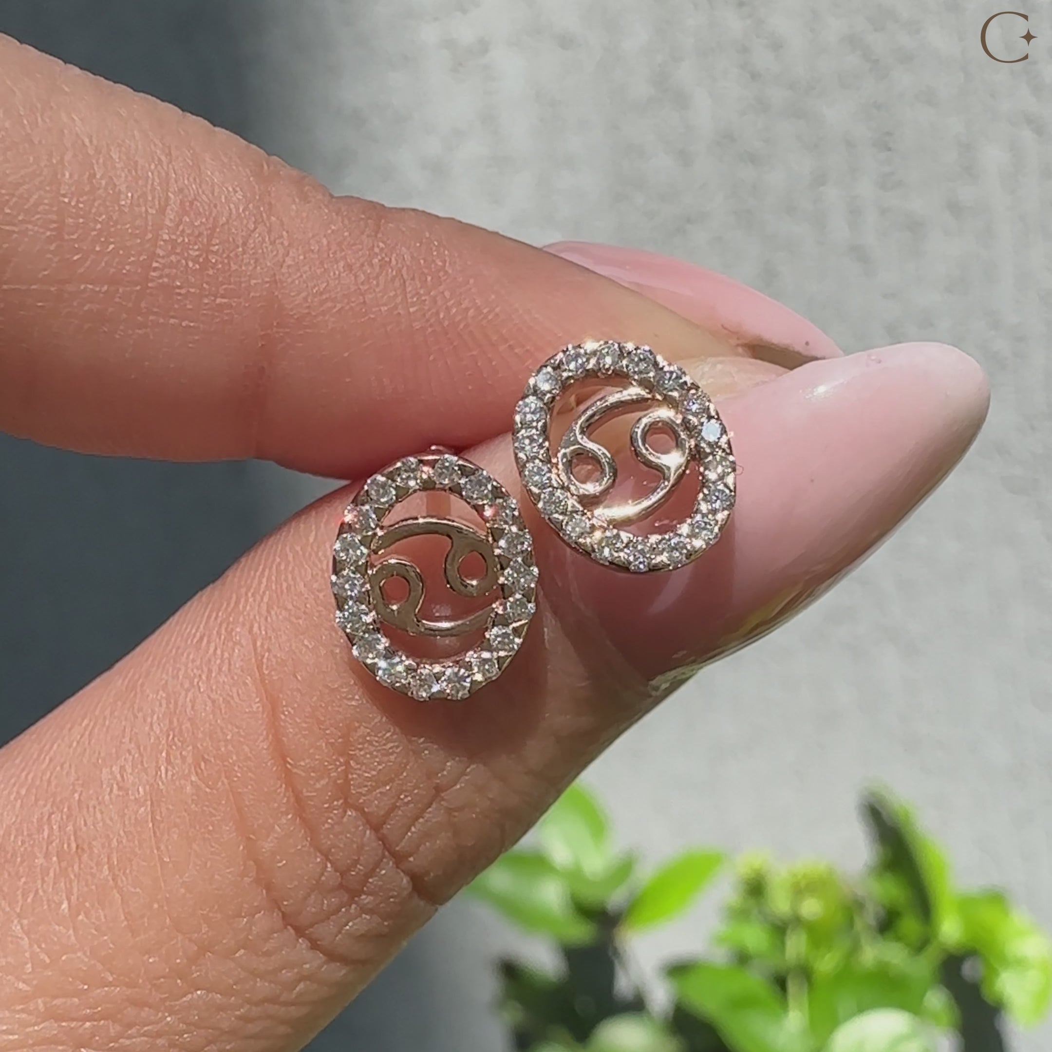 Handmade Cancer stud earrings featuring halo diamond design.
