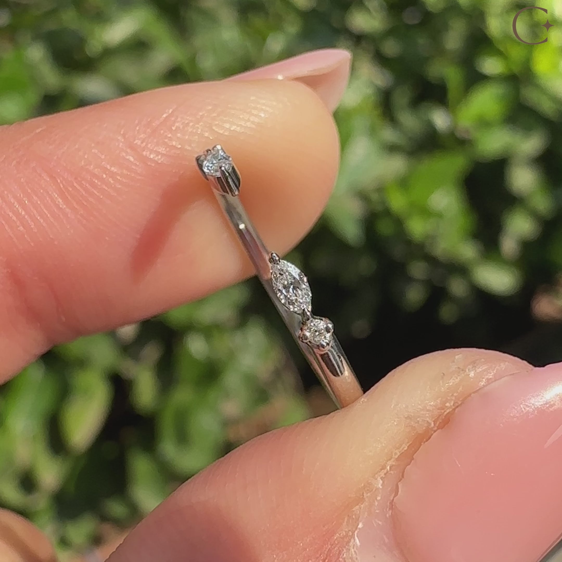 Marquise and round diamond band in modern open style.
