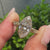 Marquise cut center diamond framed by a dotted bezel edge.
