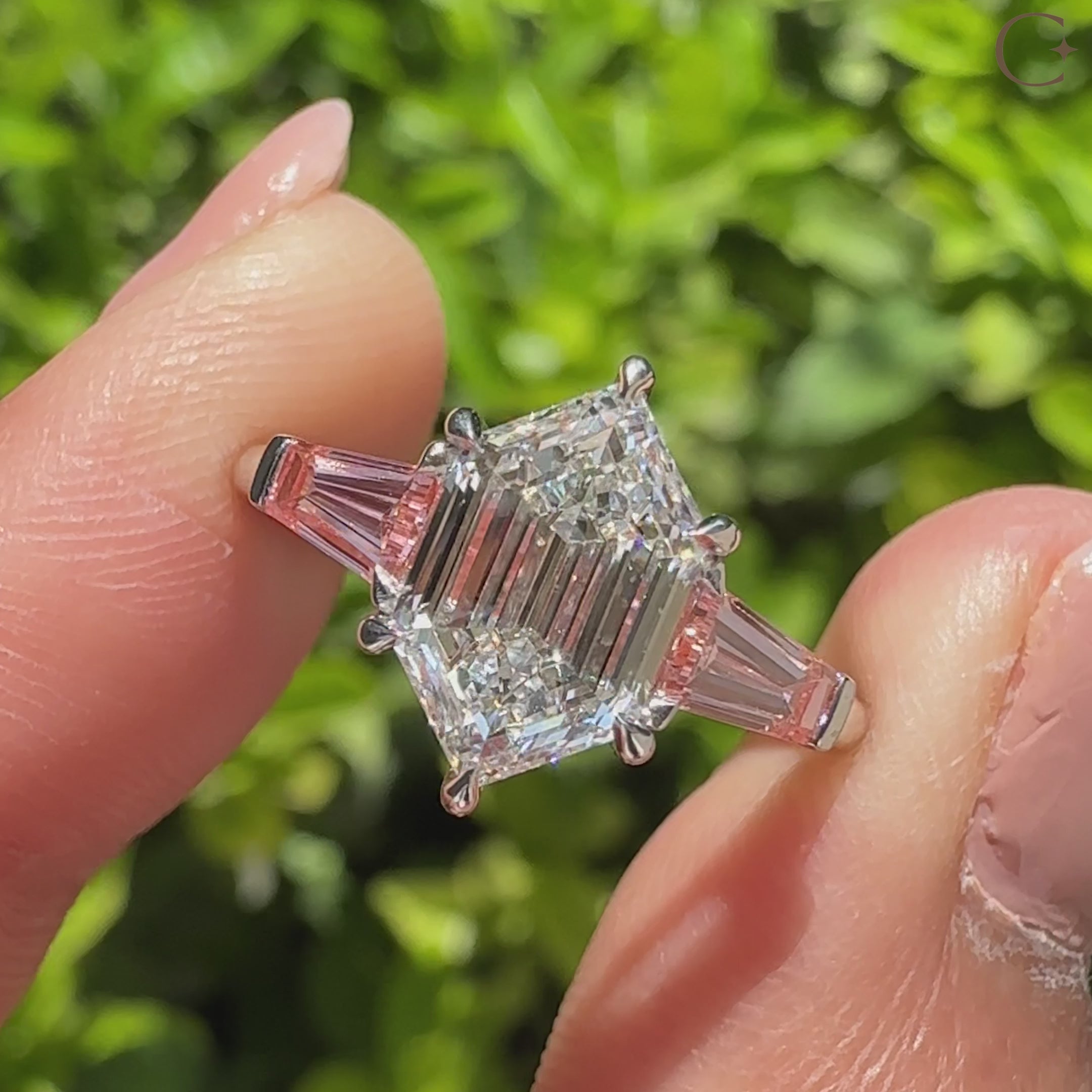 Hexagon step cut diamond ring with pink baguette sides
