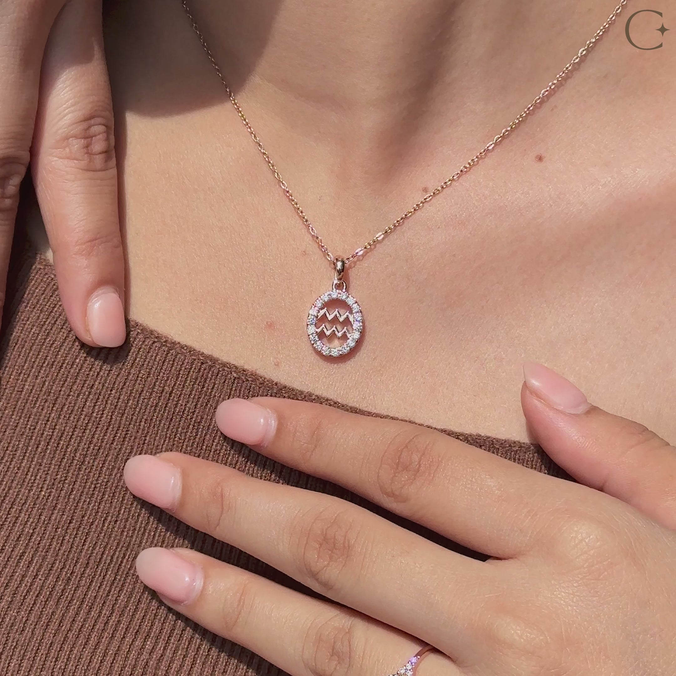 Handmade Aquarius pendant in rose gold with halo diamond design.