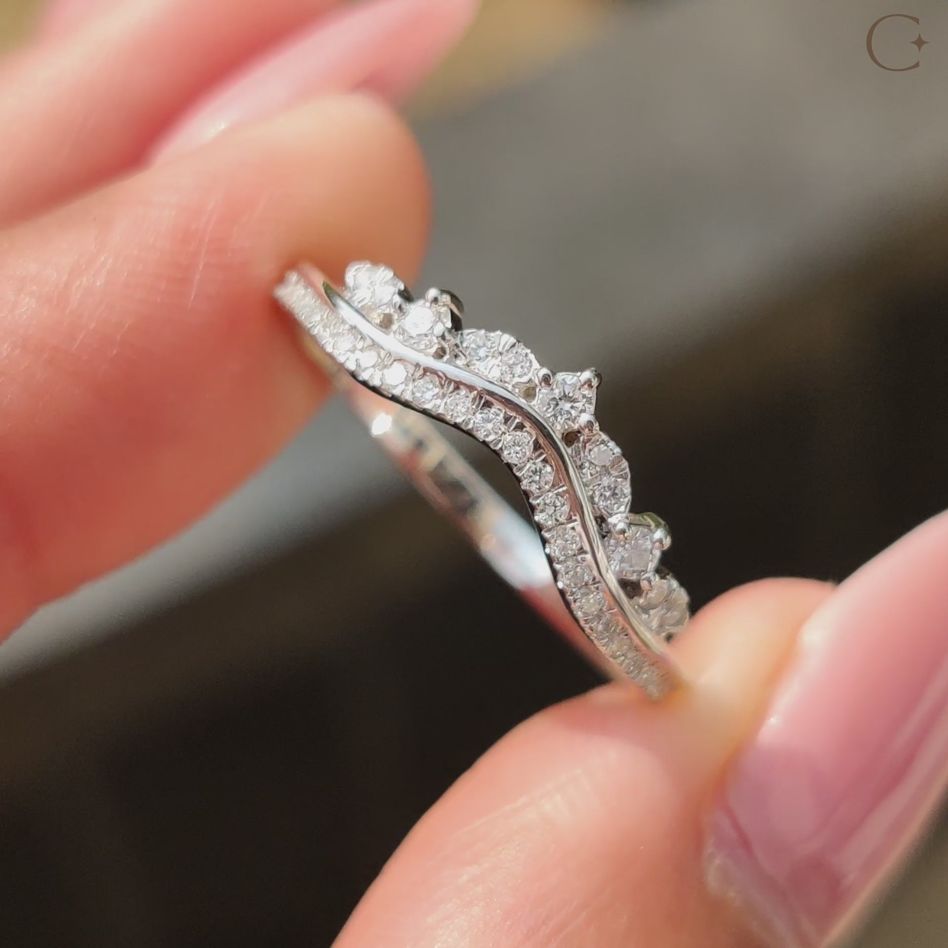 Curved wedding band featuring delicate diamonds.
