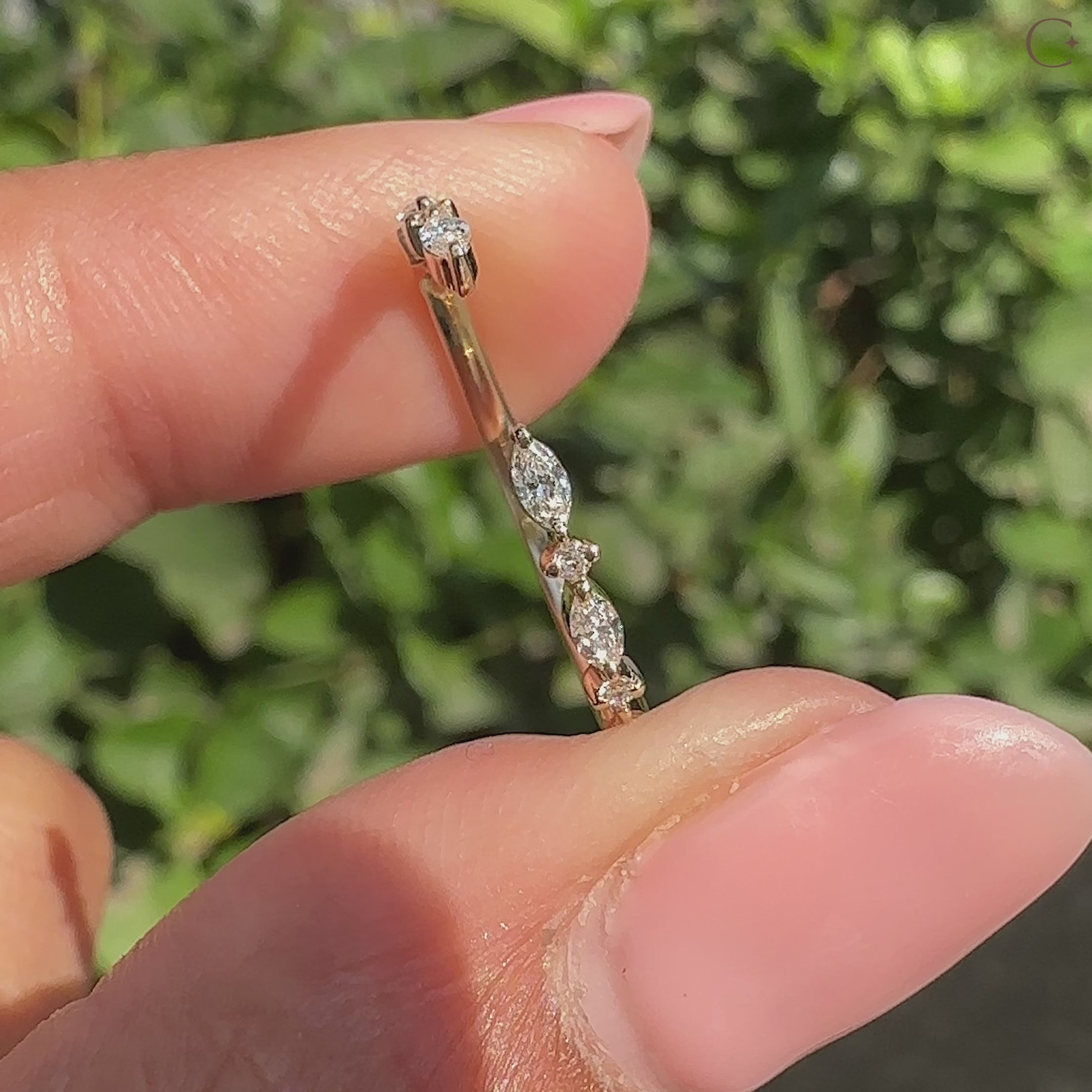 Round diamond wedding band with a shared prong style.
