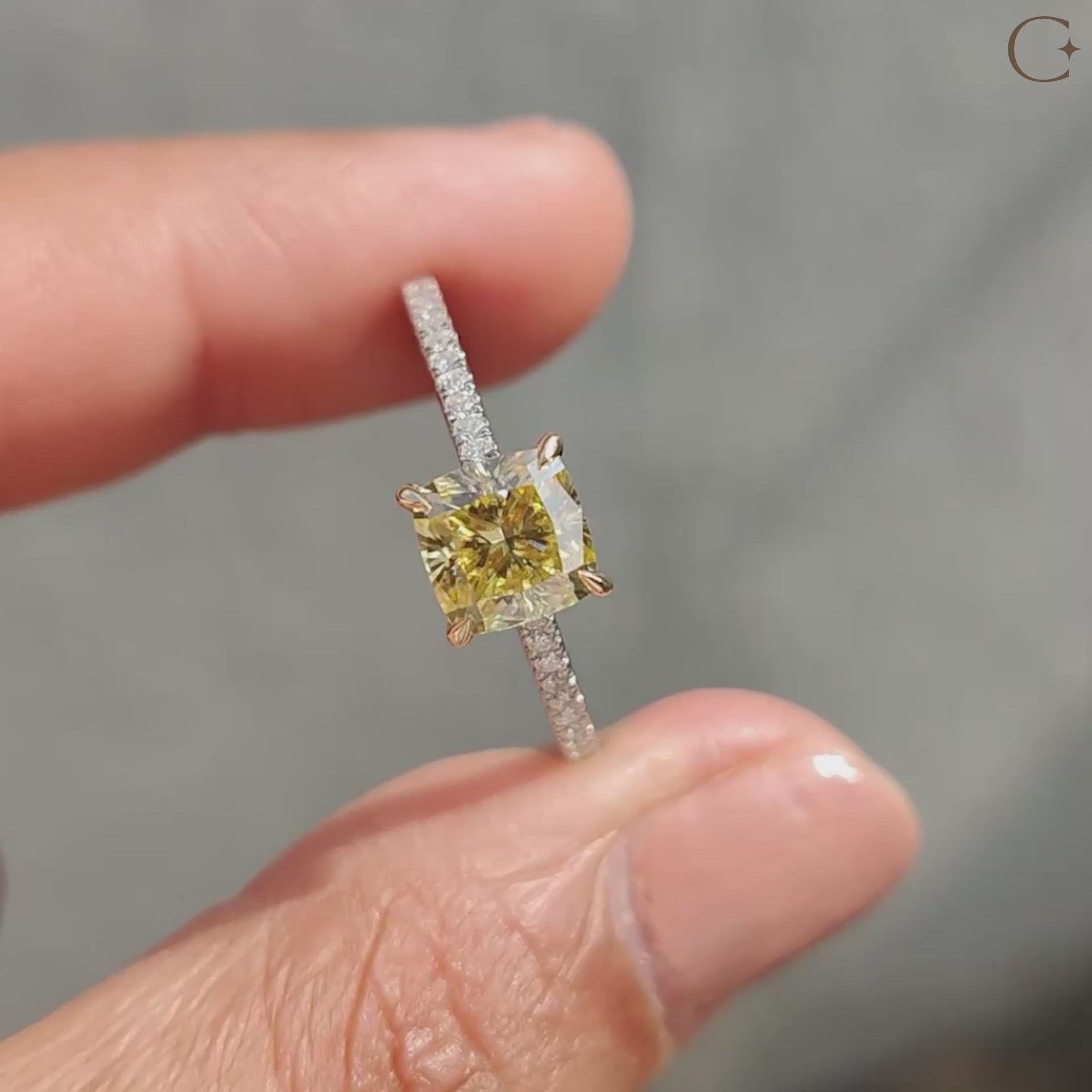 Cushion cut moissanite ring, featuring intricate pave setting and yellow gold band for a luxurious look.