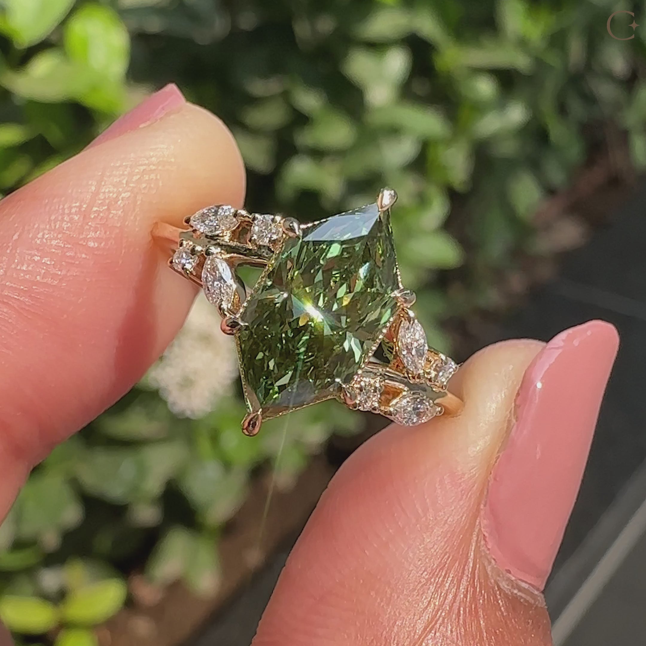 Green diamond dutch marquise ring with side stones.
