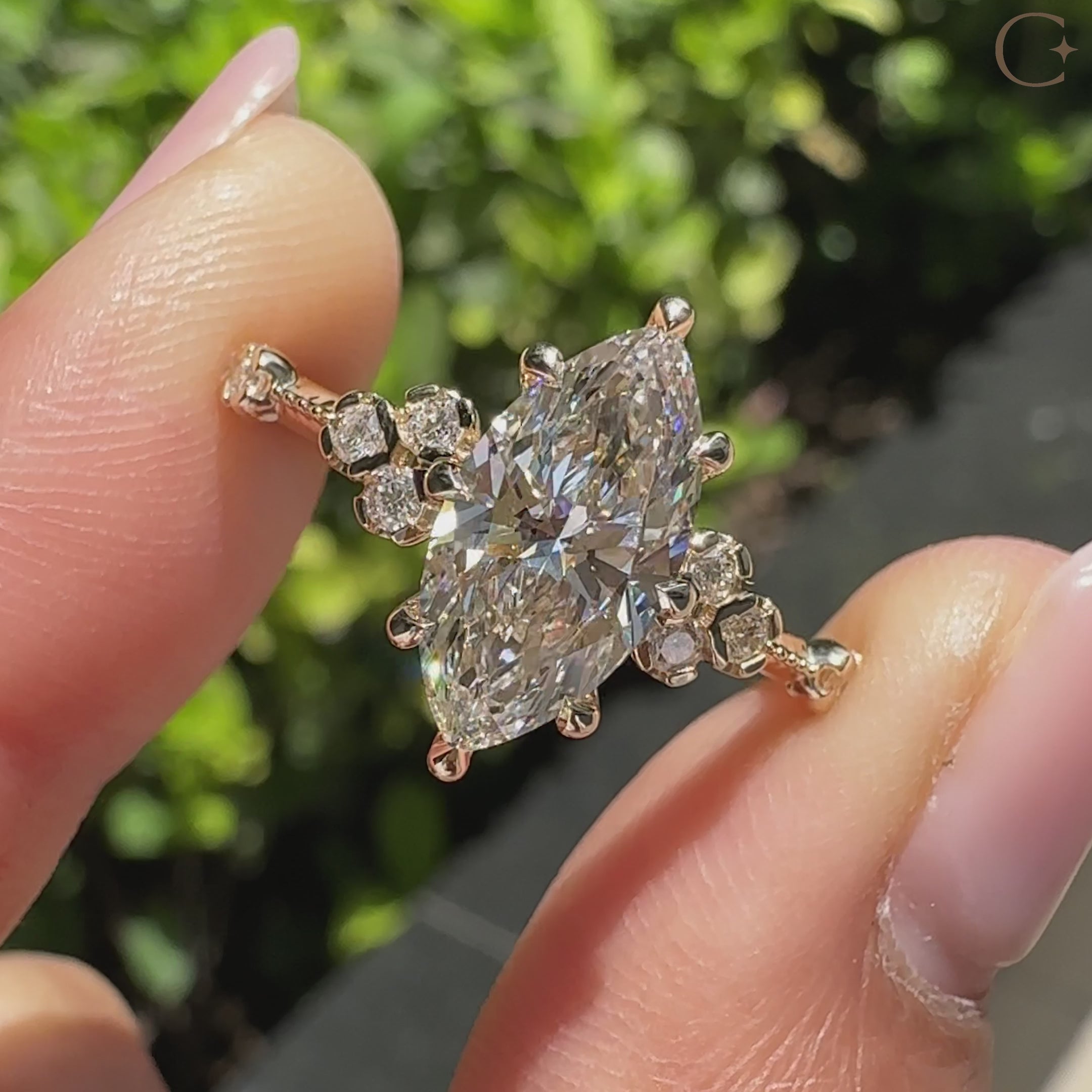 Vintage style marquise diamond ring with round side stones.
