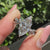 Marquise diamond ring with round side stones and halo.
