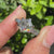Three stone diamond ring with geometric hexagon center stone.