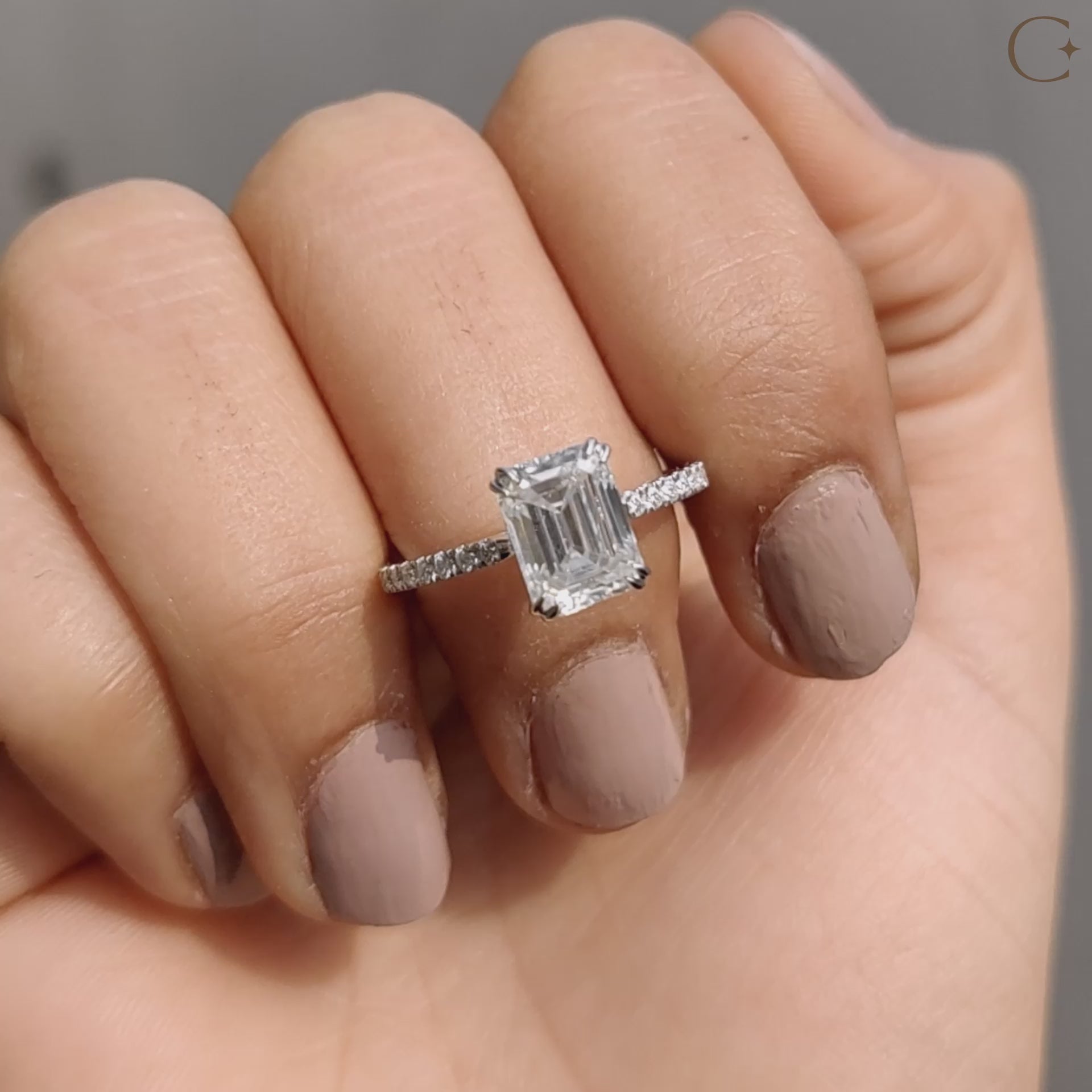 Emerald cut moissanite ring in a pave setting.
