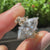 Two tone nature inspired ring with marquise center diamond and round side stones