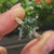 Green Dutch marquise engagement ring with marquise and round side stones
