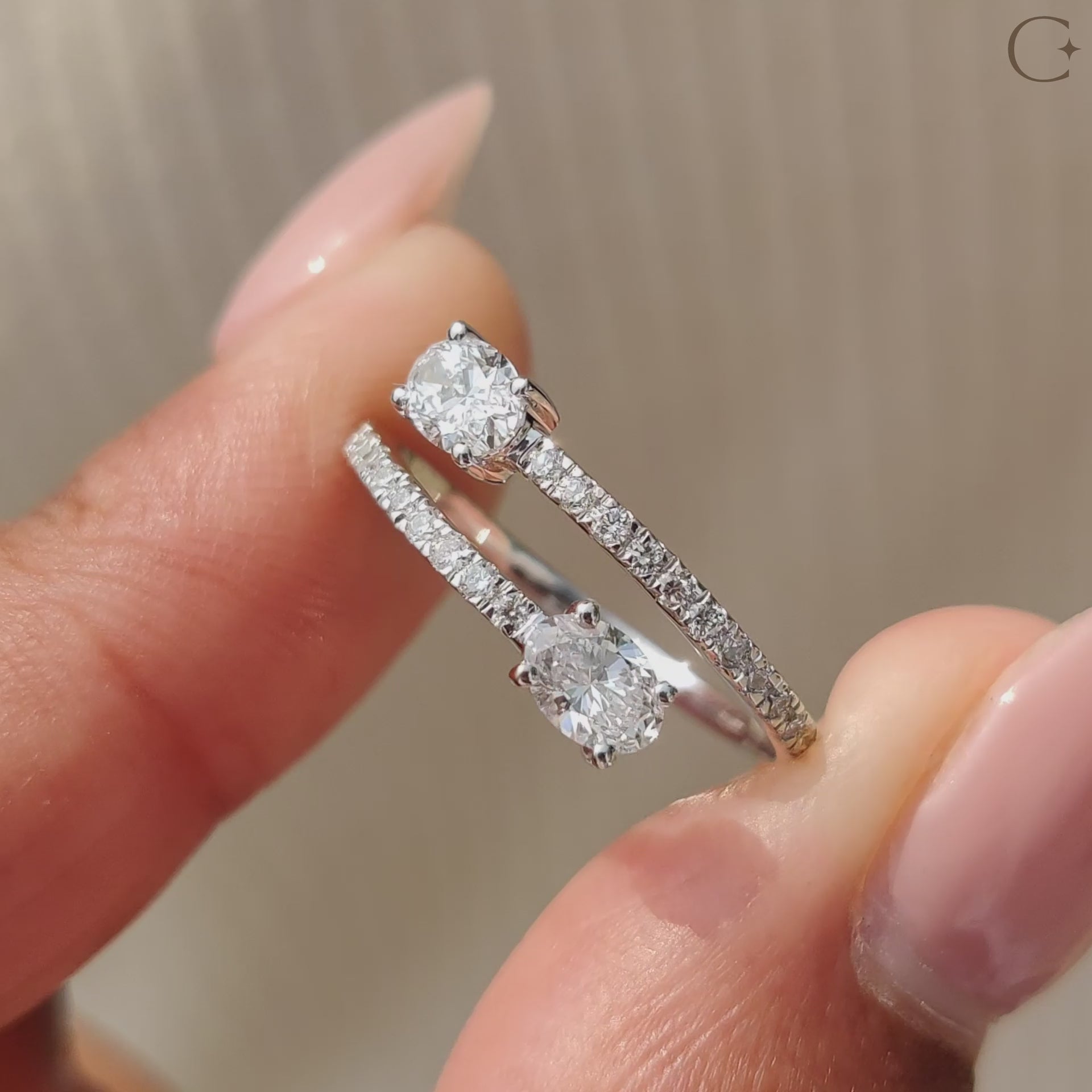 Bypass engagement ring wraps two sides around the center stone.
