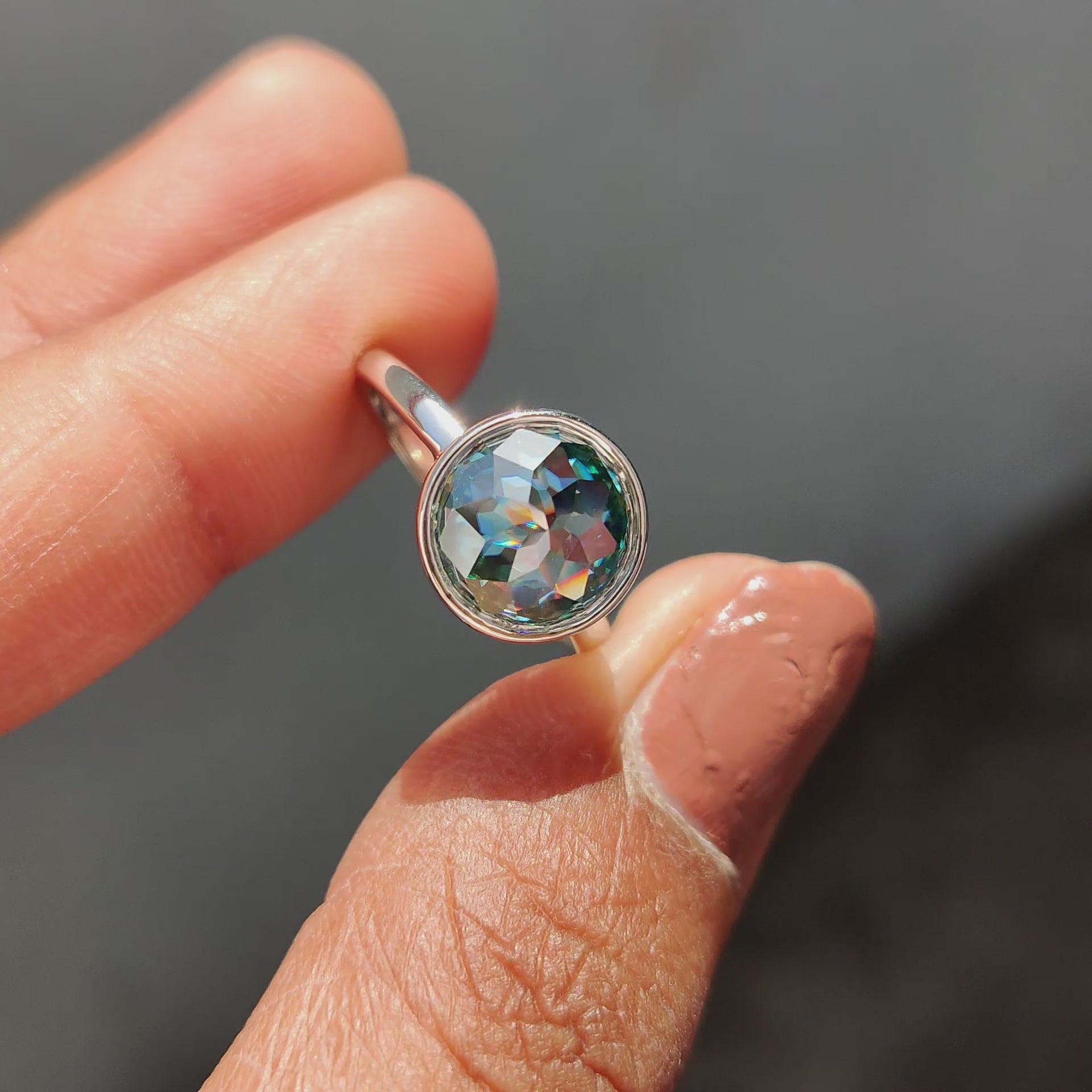 Rose cut engagement ring featuring a stunning green Moissanite stone in a simple solitaire style.