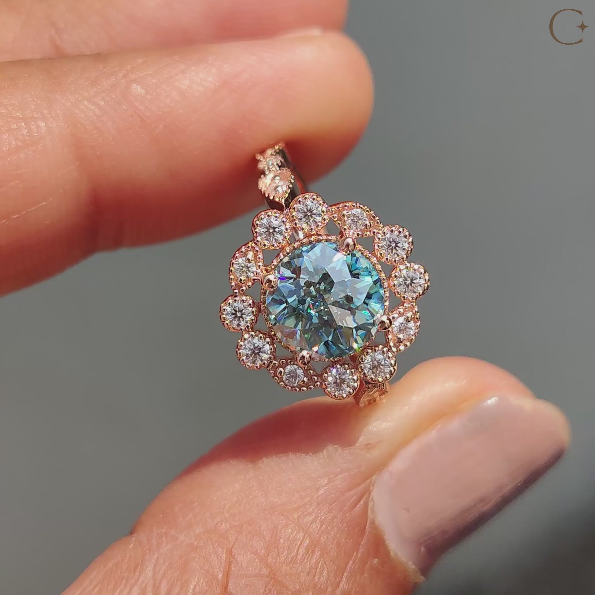 Cyan blue moissanite ring in a rose gold bridal set with a vintage style.
