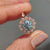 Cyan blue moissanite ring in a rose gold bridal set with a vintage style.
